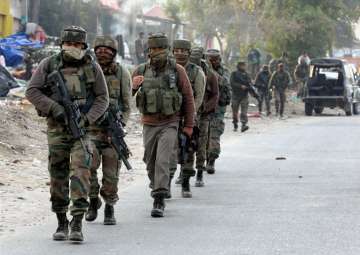 Security personnel take positions during a militants attack at Sunjwan Army camp in Jammu on Saturday
