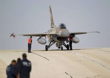 FILE - In this Monday, Nov 25, 2013, file photo, technicians inspect an Israeli air force F-16 jet at the Ovda airbase near Eilat, southern Israel. 
