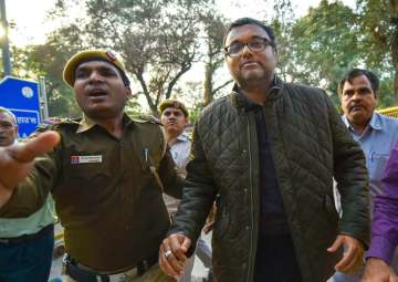 Karti Chidambaram, son of former union minister P Chidambaram escorted by police personnel to the Patiala House court in New Delhi on Wednesday
