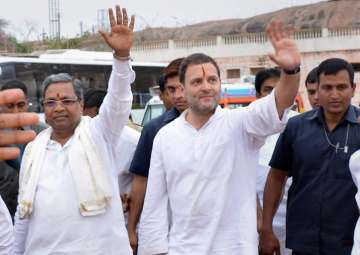 Congress President Rahul Gandhi with Karnataka Chief Minister Siddaramaiah wave to people during a rally in Koppal, Karnataka on Saturday. 