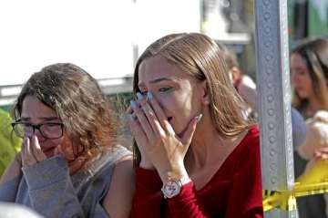 Students released from a lockdown are overcome with emotion following following a shooting at Marjory Stoneman Douglas High School in Parkland, Fla., Wednesday, Feb. 14, 2018.