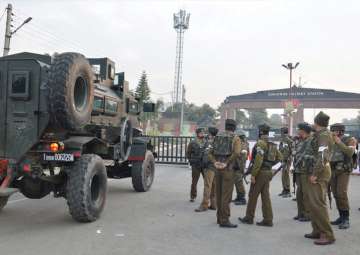 Security personnel stand guard outside the Sunjuwan Army camp during the encounter in Jammu on Saturday.
