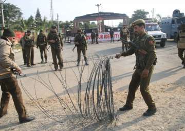 Security personnel place the barbed wires outside the Sunjwan Army camp in Jammu on Saturday.
