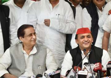 SP president Akhilesh Yadav with senior leader Azam Khan addresses a press conference after the by-election results, at the party headquarters in Lucknow on Wednesday.
