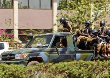 Troops ride in a vehicle near the French Embassy in central Ouagadougou, Burkina Faso, Friday March 2