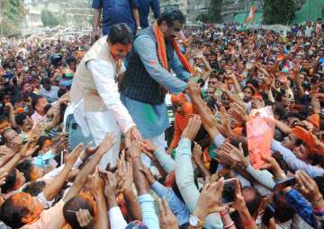 BJP National General Secretary Ram Madhav and Tripura BJP chief Biplab Kumar Deb greet the supporters after party's victory in Tripura Assembly elections results in Agartala on Saturday.