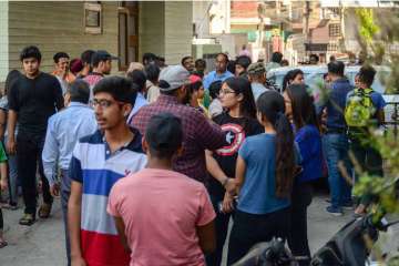 Students and parents gather outside a coaching center in Delhi's Rajendra Nagar.