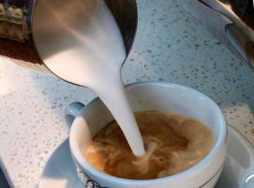 ?A barista pours steamed milk in a coffee at a cafe in Los Angeles