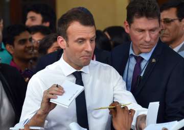 French President Emmanuel Macron interacts with students at Bikaner House in New Delhi on Saturday.