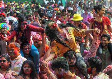 People dance during 'Rangotsav 'as they celebrate the festival of Holi at P.C.Chandra Garden in Kolkata on Friday. 