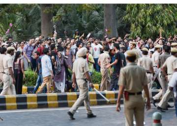 Police try to disperse JNU students as they raise slogans at a protest over the issue of compulsory attendance and other issues in New Delhi.