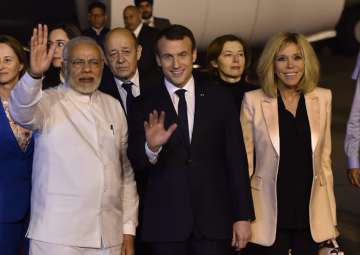 PM Narendra Modi with French President Emmanuel Macron and his wife Brigitte Macron upon their arrival at AFS Palam in New Delhi on Friday.
