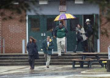 Teachers and school employees depart Great Mills High School, the scene of a shooting, Tuesday, March 20