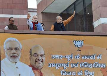 Prime Minister Narendra Modi and BJP President Amit Shah wave as they arrive to address BJP party workers after their victory in North-East Assembly election at party headquarters in New Delhi on Saturday.