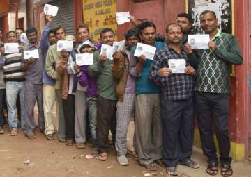 People wait in queues to cast their vote during Nagaland Assembly elections in Dimapur on Feb 27