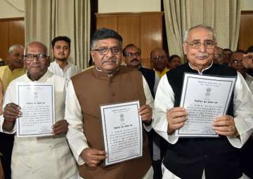 Ravi Shankar Prasad with Vashist Narayan Singh and Mahendra Singh show their certificate at Bihar Assembly in Patna on Thursday.