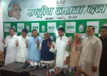 RJD leaders Tejashwi Yadav, Tej Pratap Yadav and HAM leader Jitan Ram Manjhi during a press conference in Patna