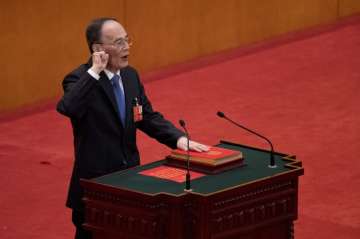 Wang Qishan takes the oath of office after being elected as vice president
