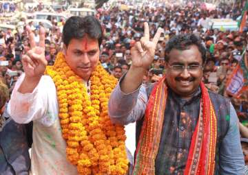 Tripura BJP president Biplab Kumar Deb along with the party's National General Secretary Ram Madhav celebrate the party's performance in the recently concluded Tripura assembly elections, in Agartala on March 3