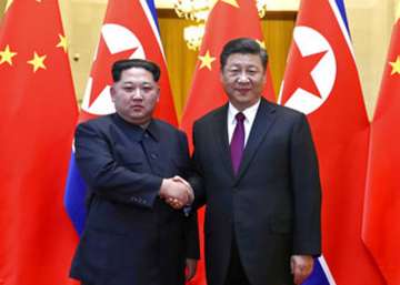 North Korean leader Kim Jong Un, left, and Chinese President Xi Jinping shake hands in Beijing, China. 