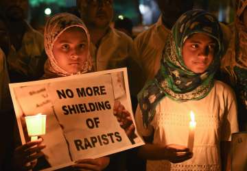Girls during a candle light vigil against the brutal rape and murder of 8-year-old Kathua girl and demanding for justice in Bengaluru on Saturday