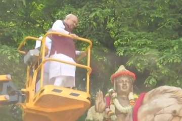 BJP president Amit Shah garlanding  statue of Lord Basaveshwara in Bengaluru. 