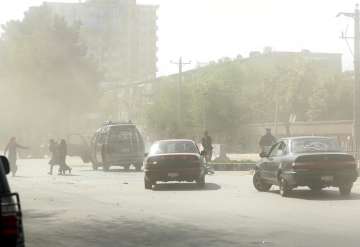 People leave the site of a suicide attack after the second bombing in Kabul