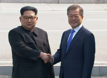 North Korean leader Kim Jong Un, left, shakes hands with South Korean President Moon Jae-in