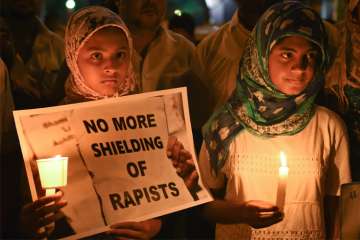 Girls during a candle light vigil against the brutal rape and murder of 8-year-old Kathua girl and demanding for justice in Bengaluru on Saturday. 
