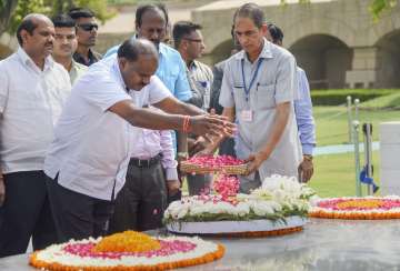 Karnataka Chief Minister H D Kumaraswamy pays tribute to Mahatma Gandhi at his memorial Rajghat, in 