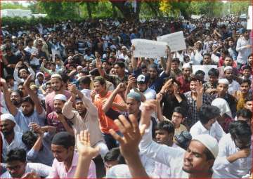 Aligarh Muslim University students stage a protest over Jinnah portrait issue in Aligarh on Friday
