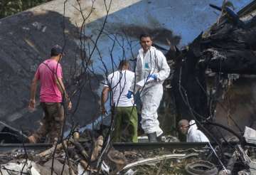 Forensic investigators and Ministry of Interior officers sift through the remains of a Boeing 737 that plummeted into a yuca field with more than 100 passengers on board, in Havana, Cuba, Friday, May 18, 2018. The Cuban airliner crashed just after takeoff from Havana’s international airport.