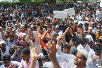 Aligarh Muslim University students stage a protest over Jinnah portrait issue in Aligarh on Friday.