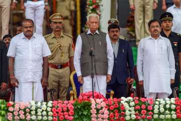 Karnataka Governor Vajubhai Vala, newly-sworn in Karnataka Chief Minister H D Kumaraswamy and Deputy Chief Minister G. Parameshwara at the swearing-in ceremony.