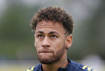 Neymar looks up during a soccer team training session in London