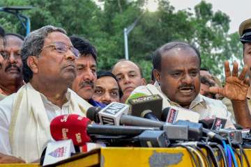 Outgoing Karnataka CM Siddaramaiah and JD(S) President HD Kumaraswamy address the media after a meeting with Governor Rudabhai Vala in relation with in Bengaluru on Tuesday.