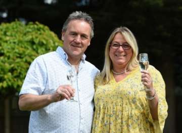 Lottery winners mow celebratory champagne bottle and glasses into their garden