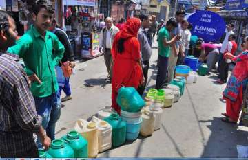 Shimla: People stand in a queue to collect water from a tanker, as the city faces acute shortage of 