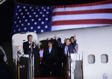 President Donald Trump, from left, greets Tony Kim, Kim Hak Song, seen in the shadow, and Kim Dong C