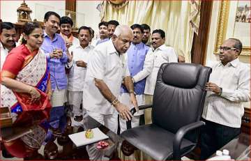Newly sworn-in Karnataka Chief Minister B. S. Yeddyurappa assumes charge at his office in Bengaluru on Thursday