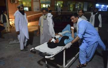 A wounded man is brought by stretcher into a hospital in Jalalabad city, capital of Nangarhar province, east of Kabul, Afghanistan on Saturday
