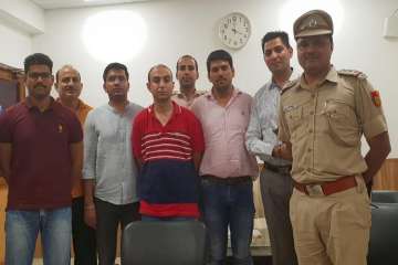 ?
Army Major, Nikhil Handa (C) (in red t-shirt), arrested, in relation to the murder of another Major's wife, from Uttar Pradesh's Meerut, in police custody in New Delhi on Sunday.