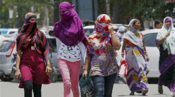 Allahabad: Girls cover their faces to beat the heat on a hot day