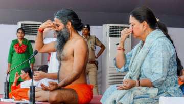 Yoga guru Ramdev and Rajasthan chief minister Vasundhara Raje perform yoga during an event to set the Guinness World Record for 'The Largest Yoga Lesson.