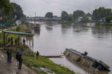 A houseboat capsized during heavy rains at Jehlum, in Srinagar, on Friday, June 29.