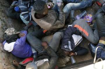 Migrants being expelled from Algeria lie in a truck headed towards the Niger border at Point Zero, from which they must walk south into the Sahara Desert towards the Nigerien border post of Assamaka, 10 miles south.?