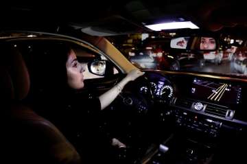 Hessah al-Ajaji drivers her car down the capital’s busy Tahlia Street after midnight for the first time in Riyadh, Saudi Arabia on Sunday