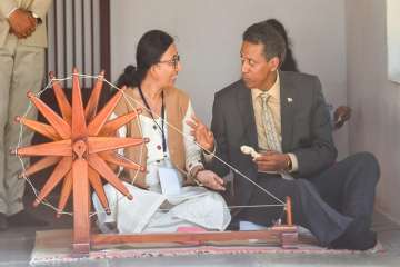 Seychelles President Danny Faure tries his hand on a spinning wheel or charkha', at Gandhi Ashram in Ahmedabad on Saturday.