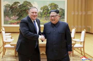 In this May 9, 2018, file photo provided by the North Korean government, US Secretary of State Mike Pompeo, left, poses with North Korean leader Kim Jong un for a photo during a meeting at Workers’ Party of Korea headquarters in Pyongyang, North Korea.