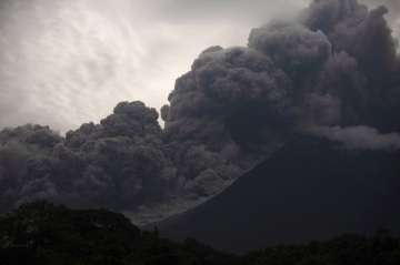 Volcan de Fuego, or Volcano of Fire, blows outs a thick cloud of ash, as seen from Alotenango, Guatemala on Sunday